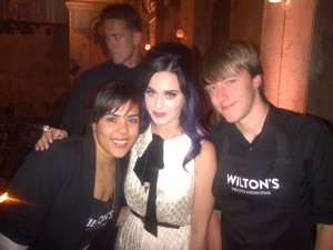 Katy Perry posing with staff of Wilton's Music Hall.
